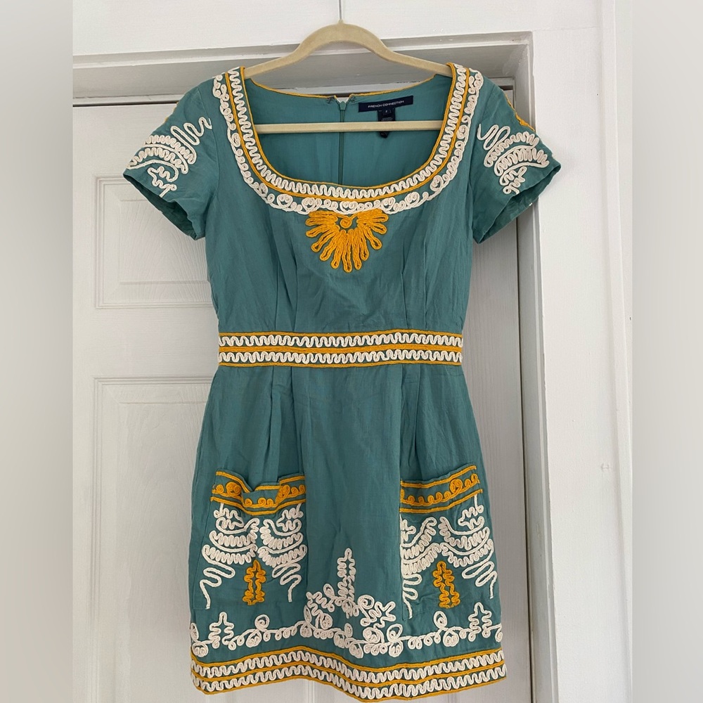 Blue embroidered mini dress with zip up back. French Connection brand. Pockets!